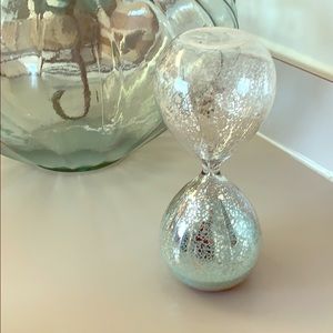 Hourglass with blue sand and silver specks